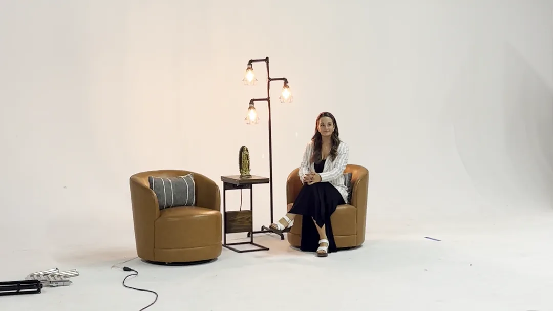 Wide view of Savannah Evans seated on the interview set during filming